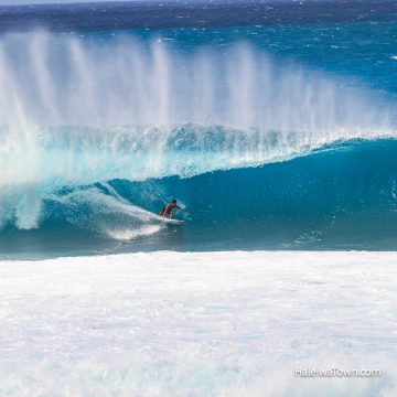 surfer surfing north shore barrel wave backside