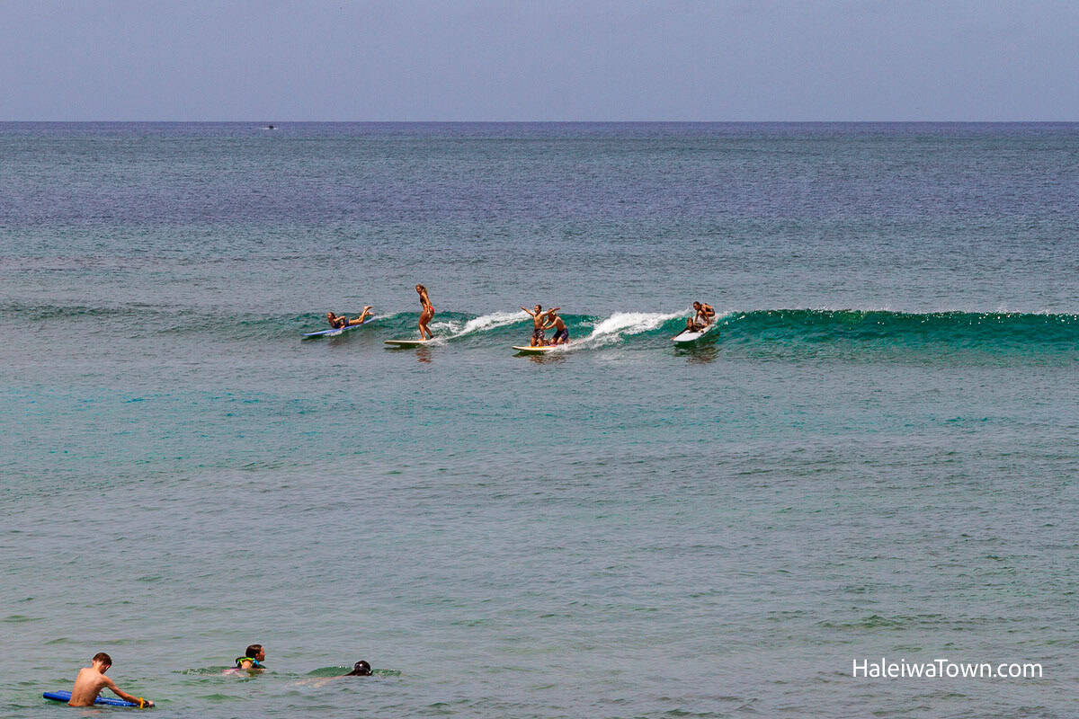 surf school on north shore oahu teaching kids on a small wave