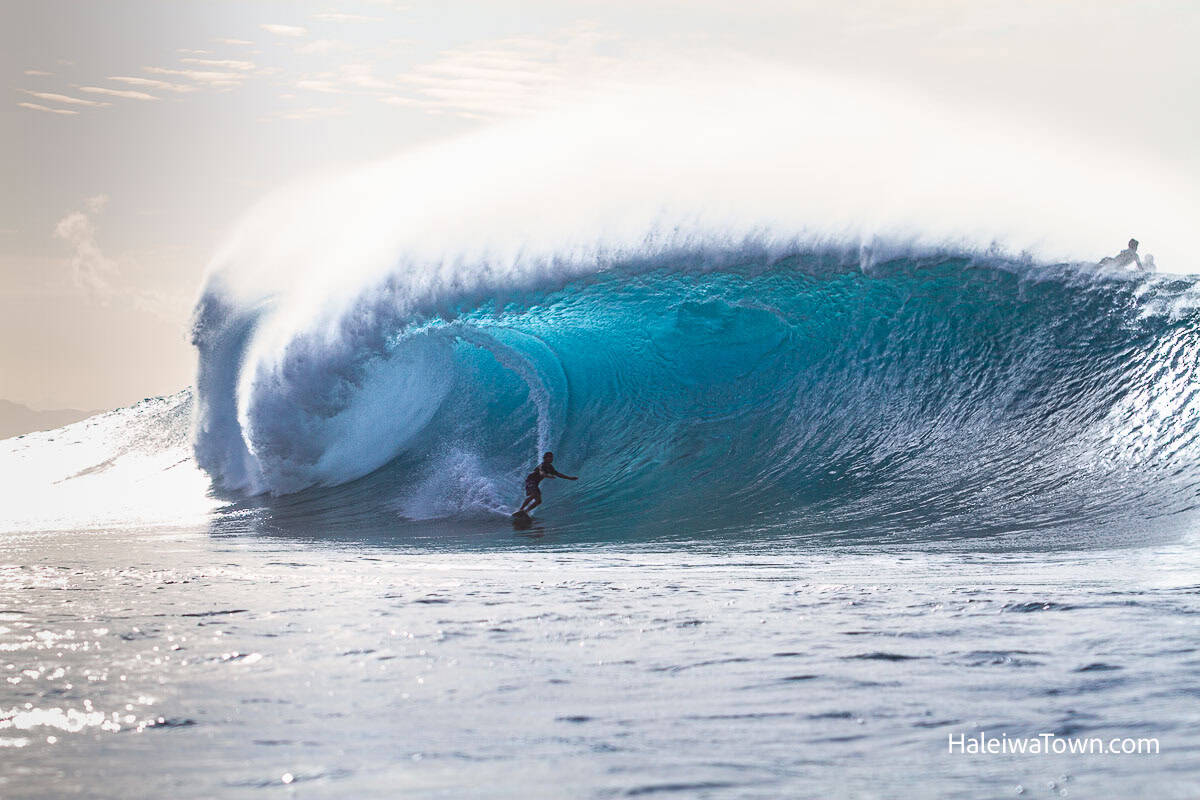 Surfer riding a heavy winter barrel at Banzai Pipeline at Ehukai Beach Park