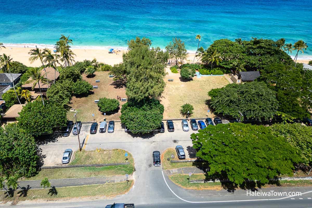 Aerial view of Ehukai Beach Park showing parking lot, grassy park area, and beach access