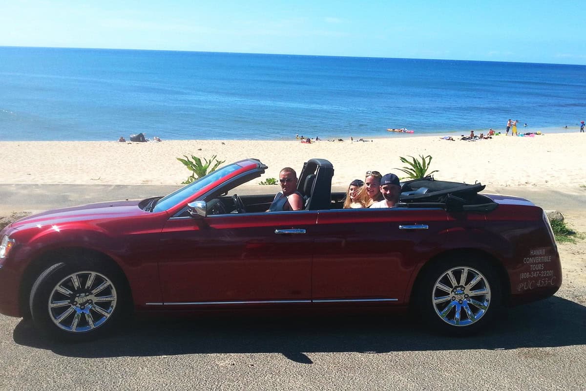 Convertible car driving along the coastline during a private guided tour